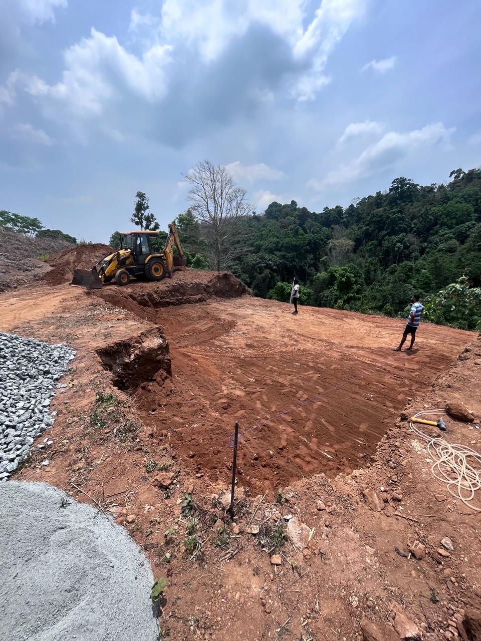 Pool excavation in progress, JCB carving the pool footprint into Kerala laterite soil