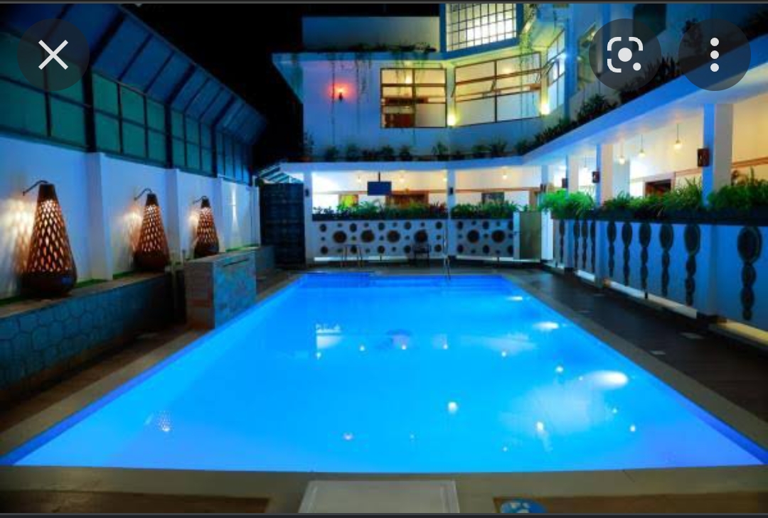 Luxury hotel pool with blue LED lighting at night